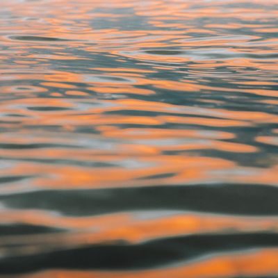 Close-up of gentle water ripples reflecting light.