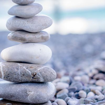 Smooth stones stacked in a zen garden.